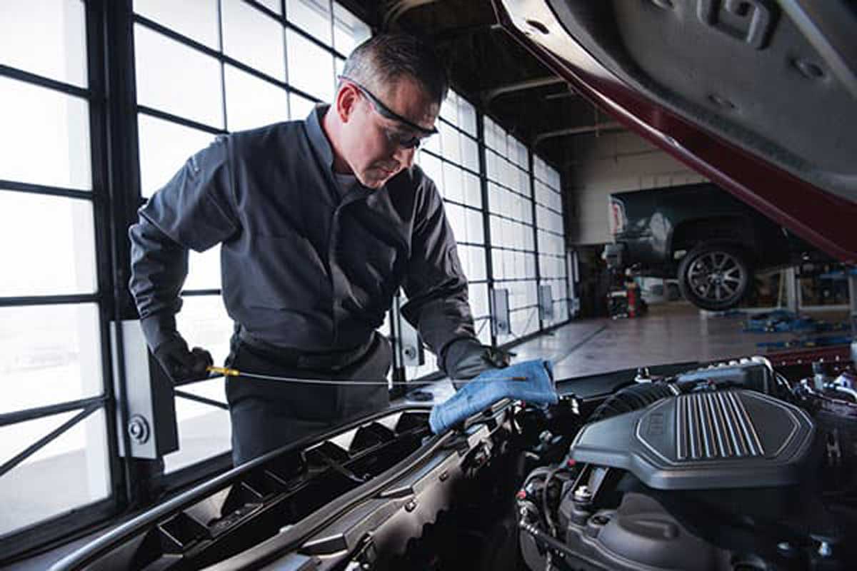 technician checking oil